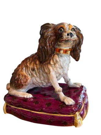 Porcelain dog on a cushion
